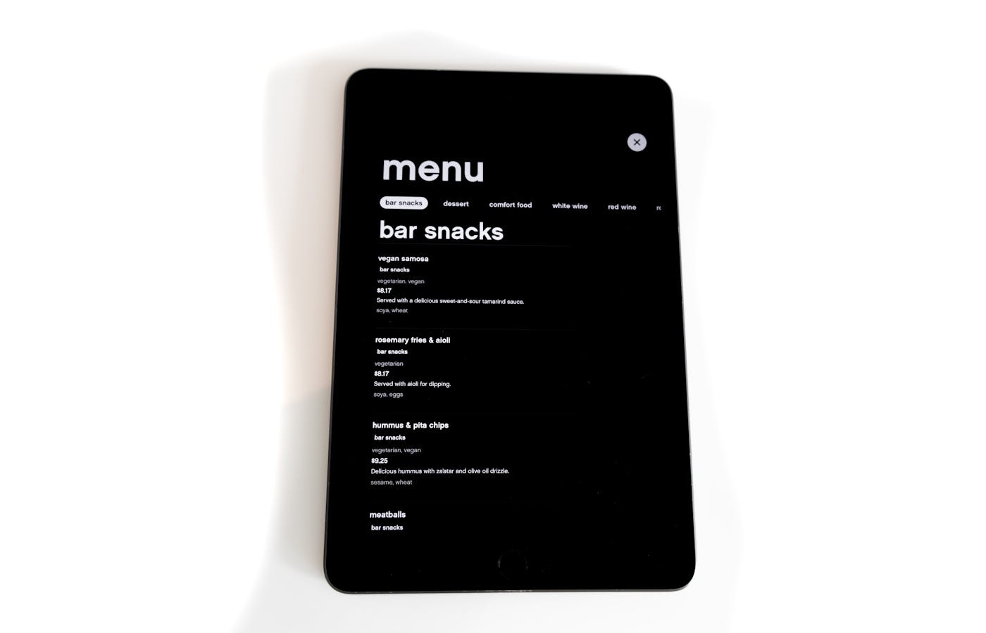 Tablet showing a restaurant menu on a simple white background.
